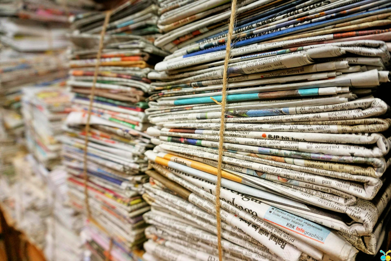 Several stacks of newspaper tied with twine