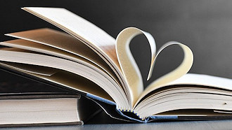 open book with pages shaped like a heart
