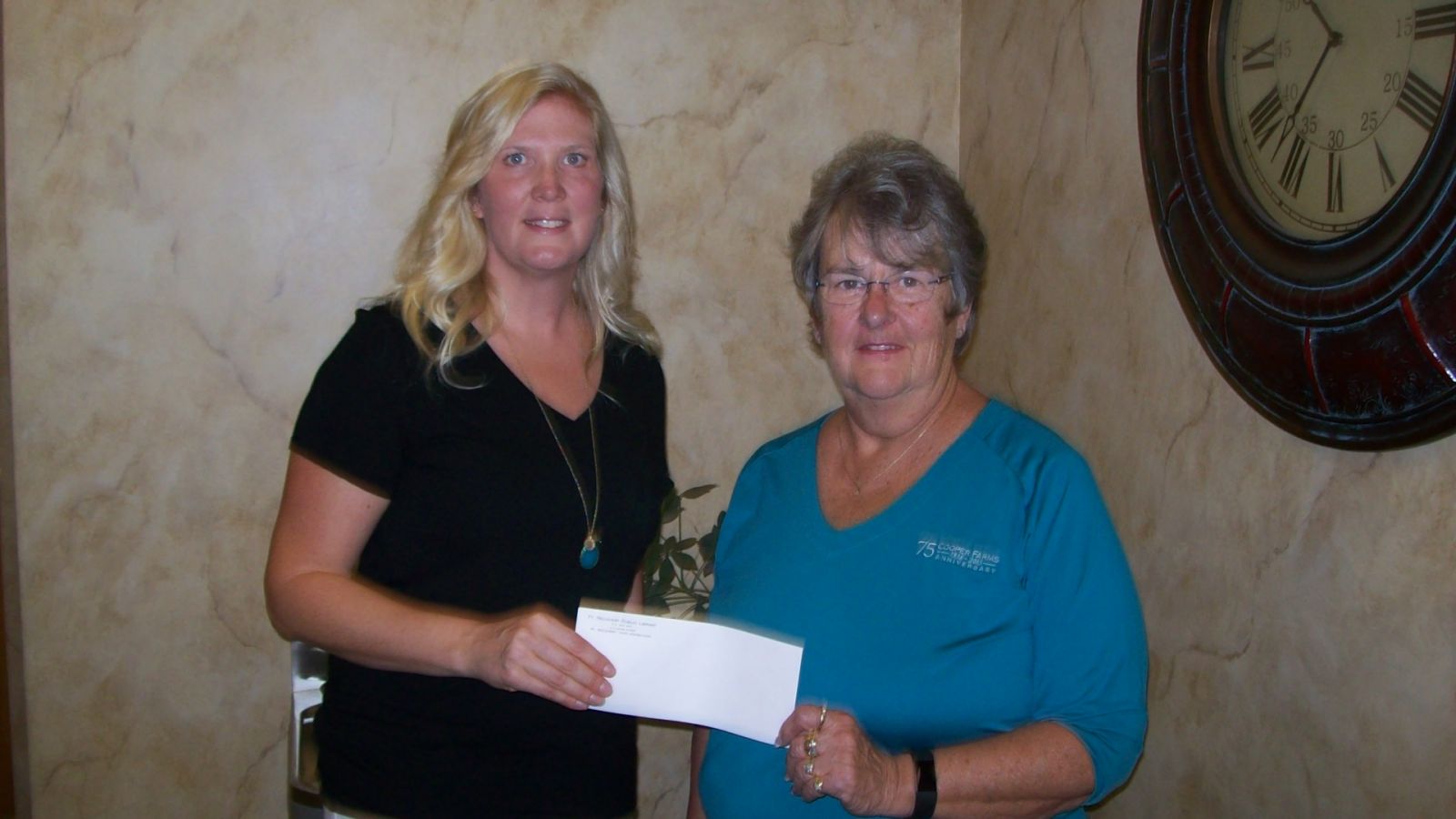 Library fiscal officer accepts check donation